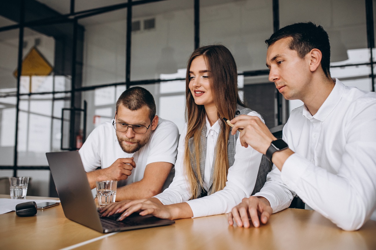 Group of people working out business plan in an office Group of people working out business plan in an office